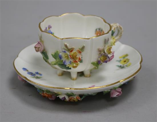 A Meissen flower encrusted cup and saucer